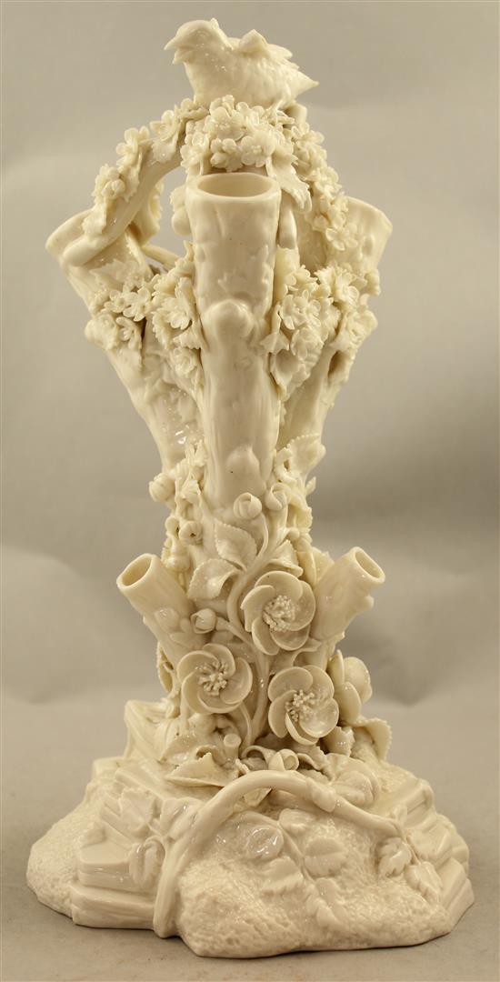 A Belleek bird and nest on a stump vase, late 19th century, 32cm, loss to bird